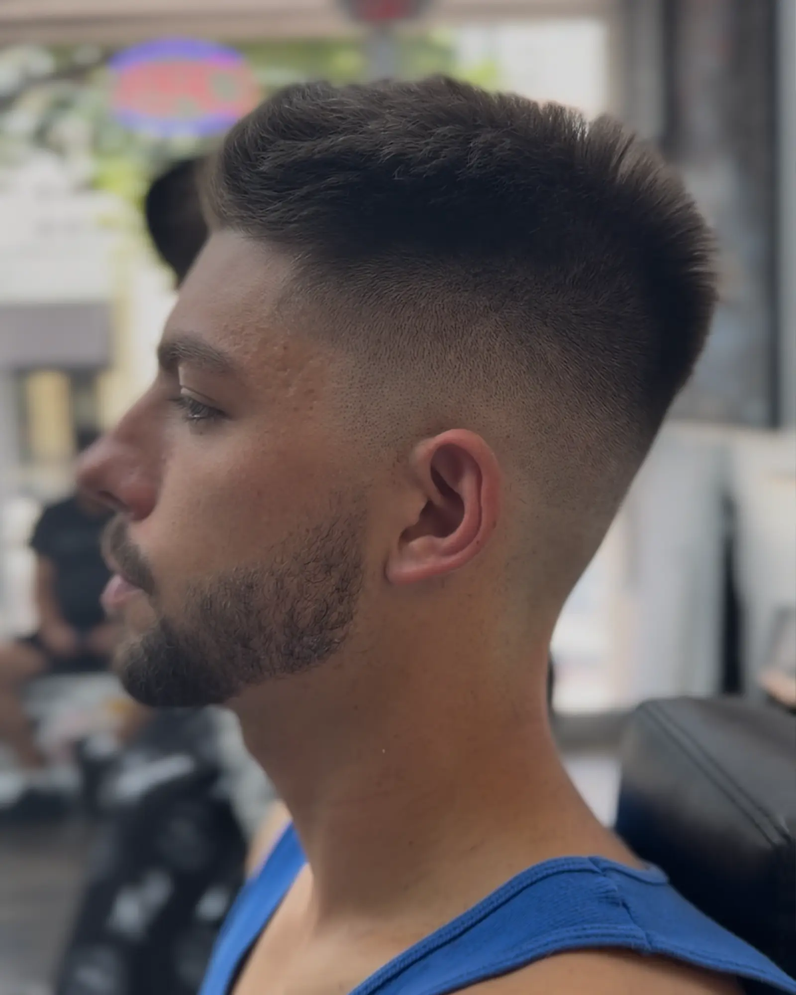 High skin fade with a textured top swept back, cut by Leo Sanchez