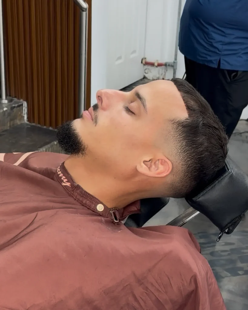 Beard lineup with a sharp cheek line and mid taper fade at Alchemy Hair Lab