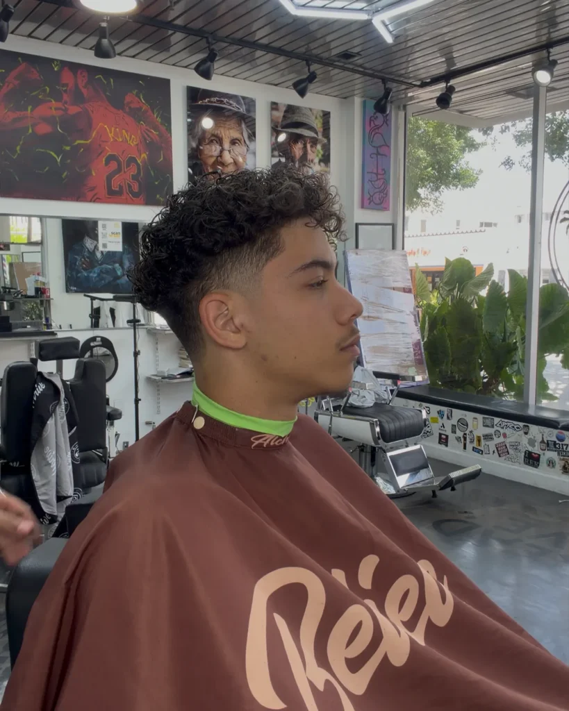Curly top with a mid taper fade, cut by Leo Sanchez in Coral Gables