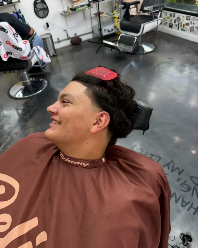 Client smiling after a sharp edge-up and textured crop by Leo Sanchez