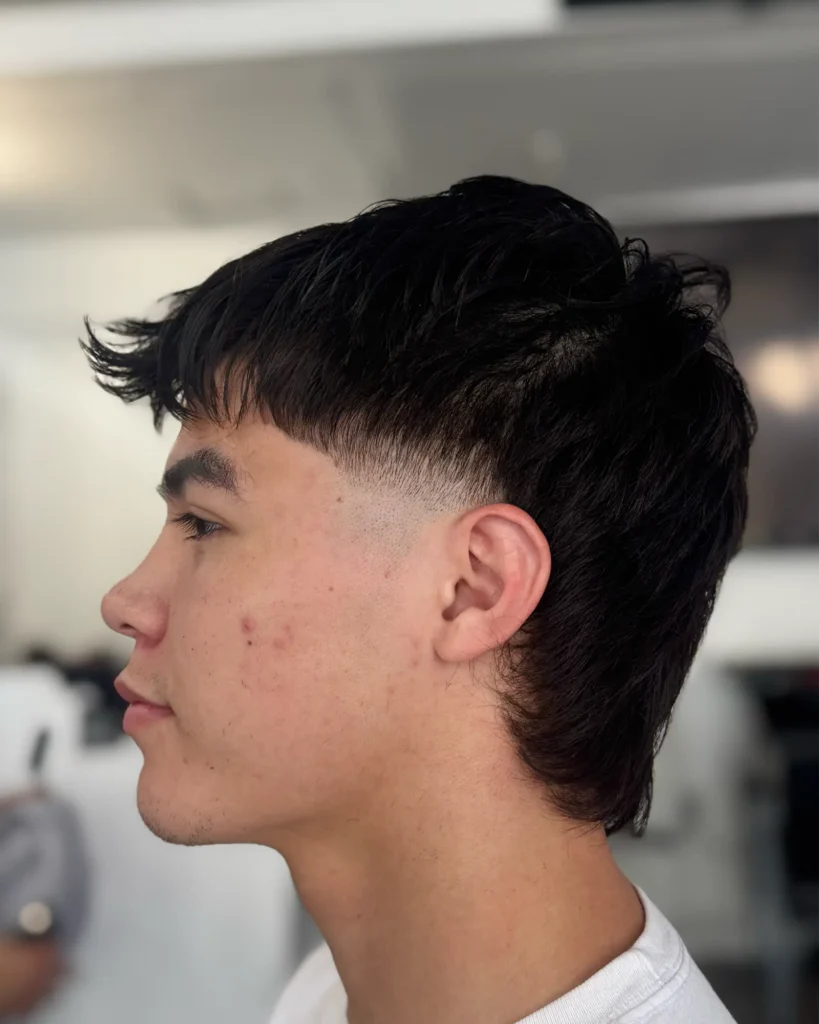 Modern mullet with a burst fade around the ear, cut by Luis Mosquera