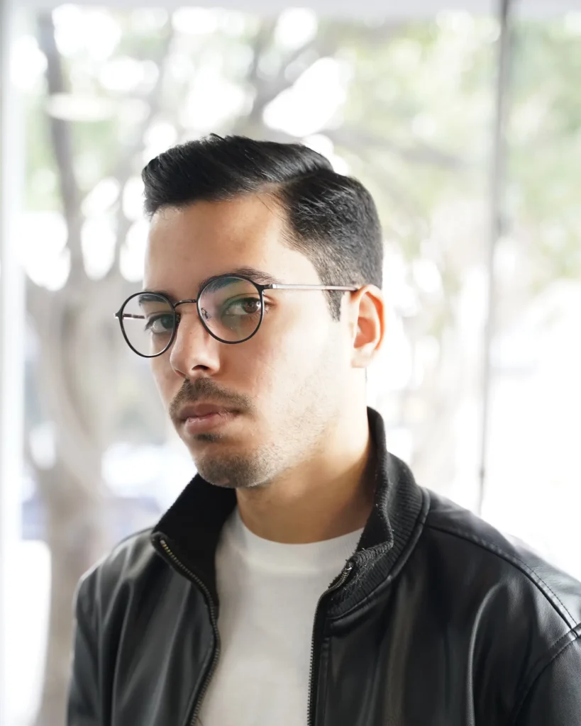 Side part with a razored hard part line, cut by Luis Mosquera