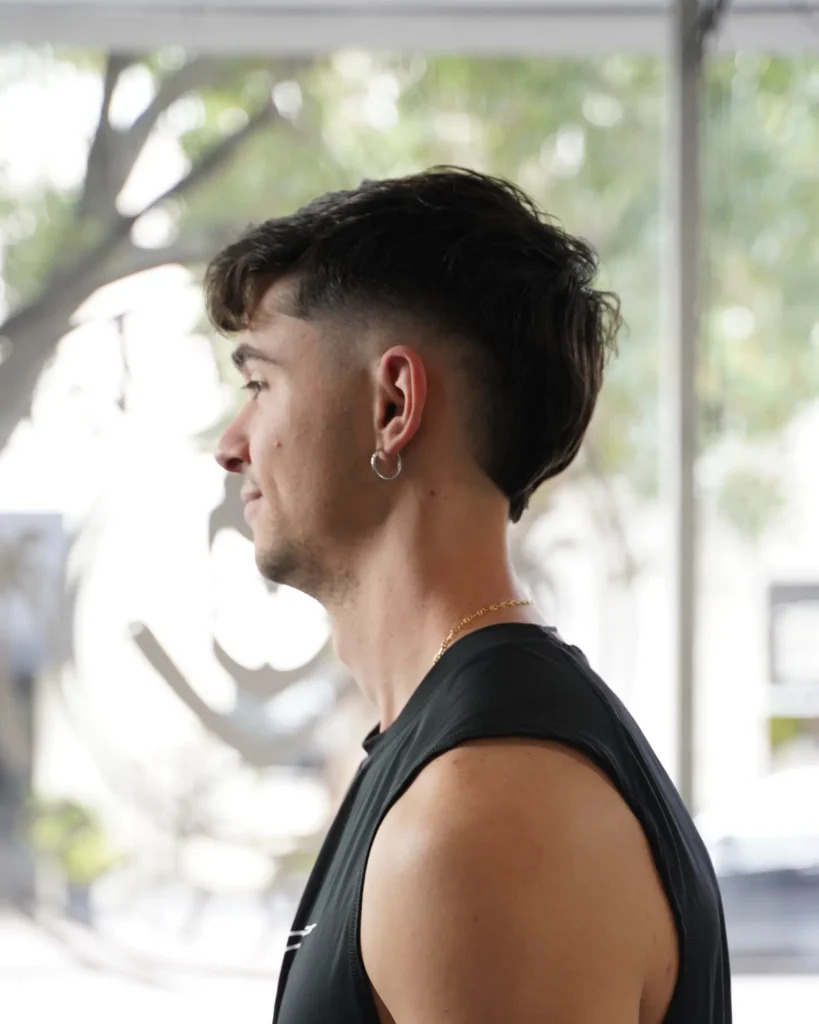 Profile of a textured mullet with a drop fade at Alchemy Hair Lab
