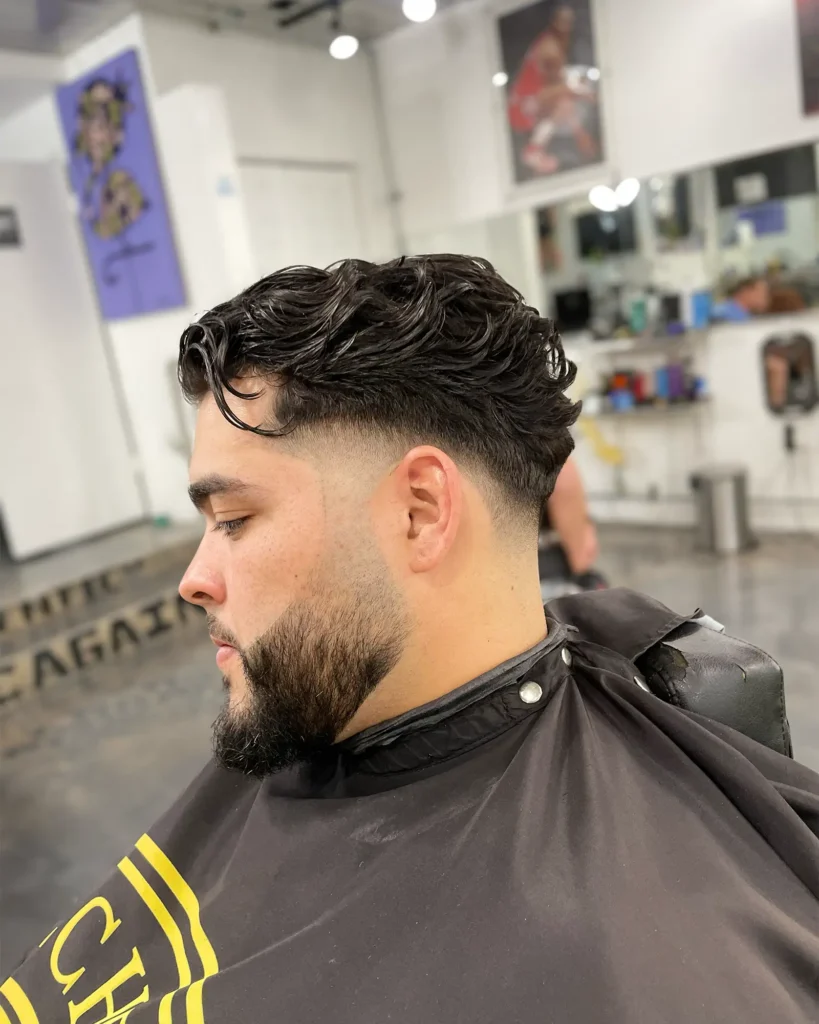 Mid taper fade with a full sculpted beard and sharp cheek line by Luis Mosquera