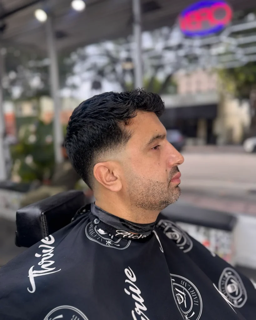 Textured top with a low taper fade, finished at Alchemy Hair Lab in Coral Gables